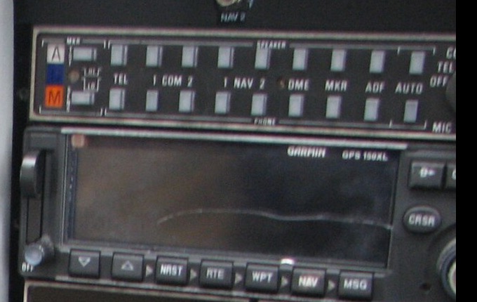 Récepteur GPS Garmin GPS 150XL encastré dans la planche de bord d'un Cessna 172, à côté des radios NAV/COM